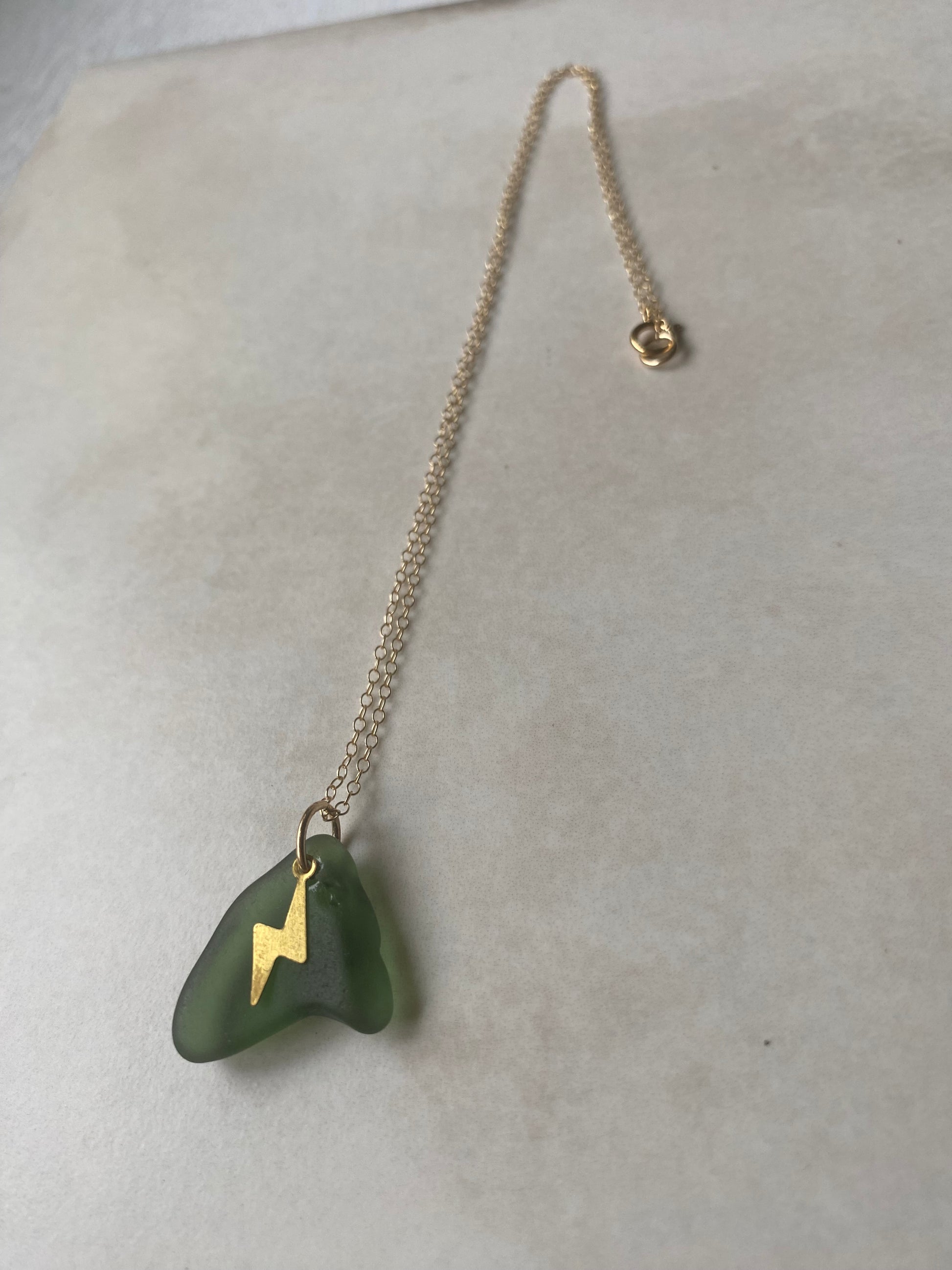 Joy sea glass necklace: Brass lightening bolt (green)