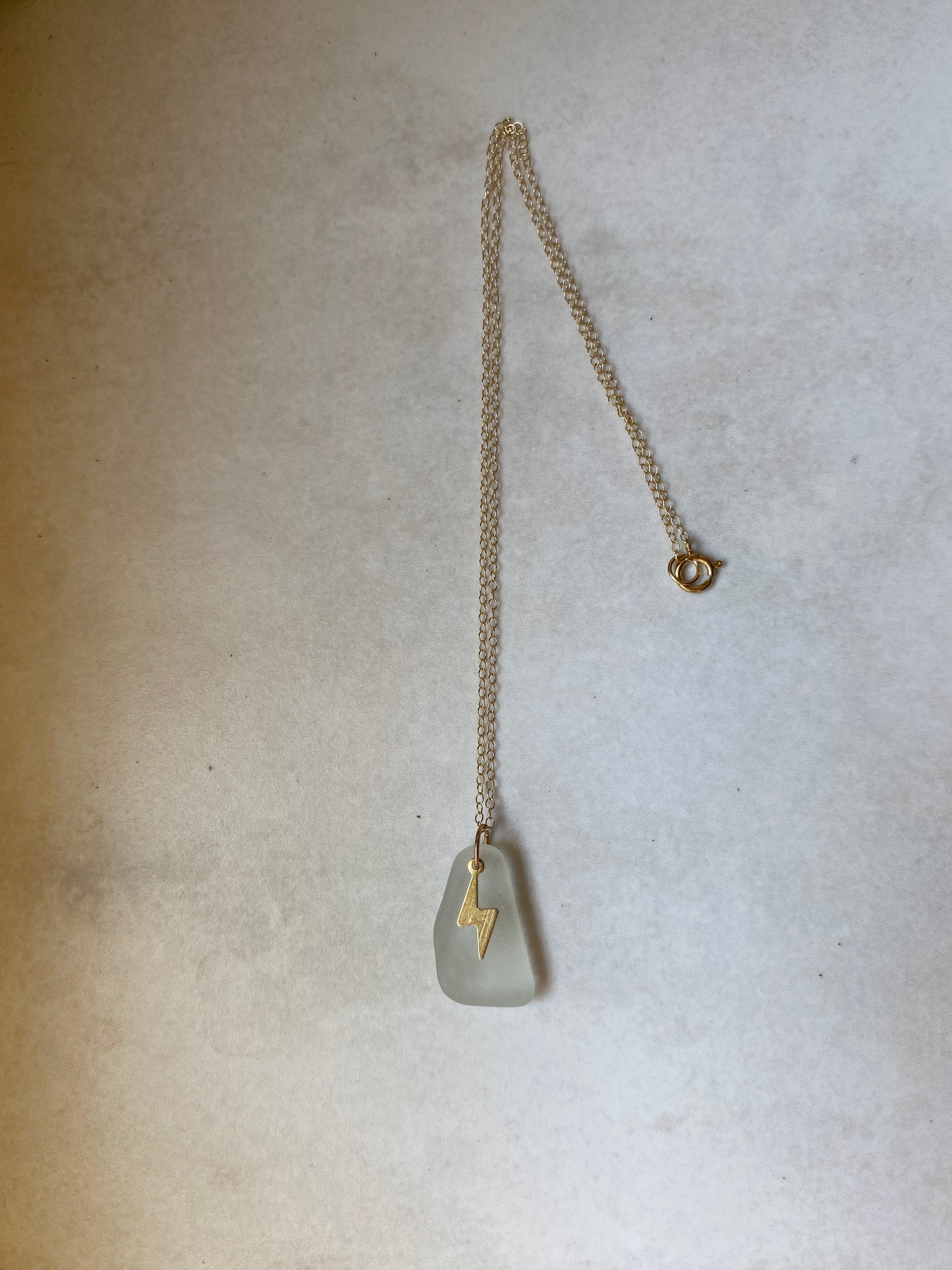 Joy sea glass necklace: Brass lightening bolt (white)