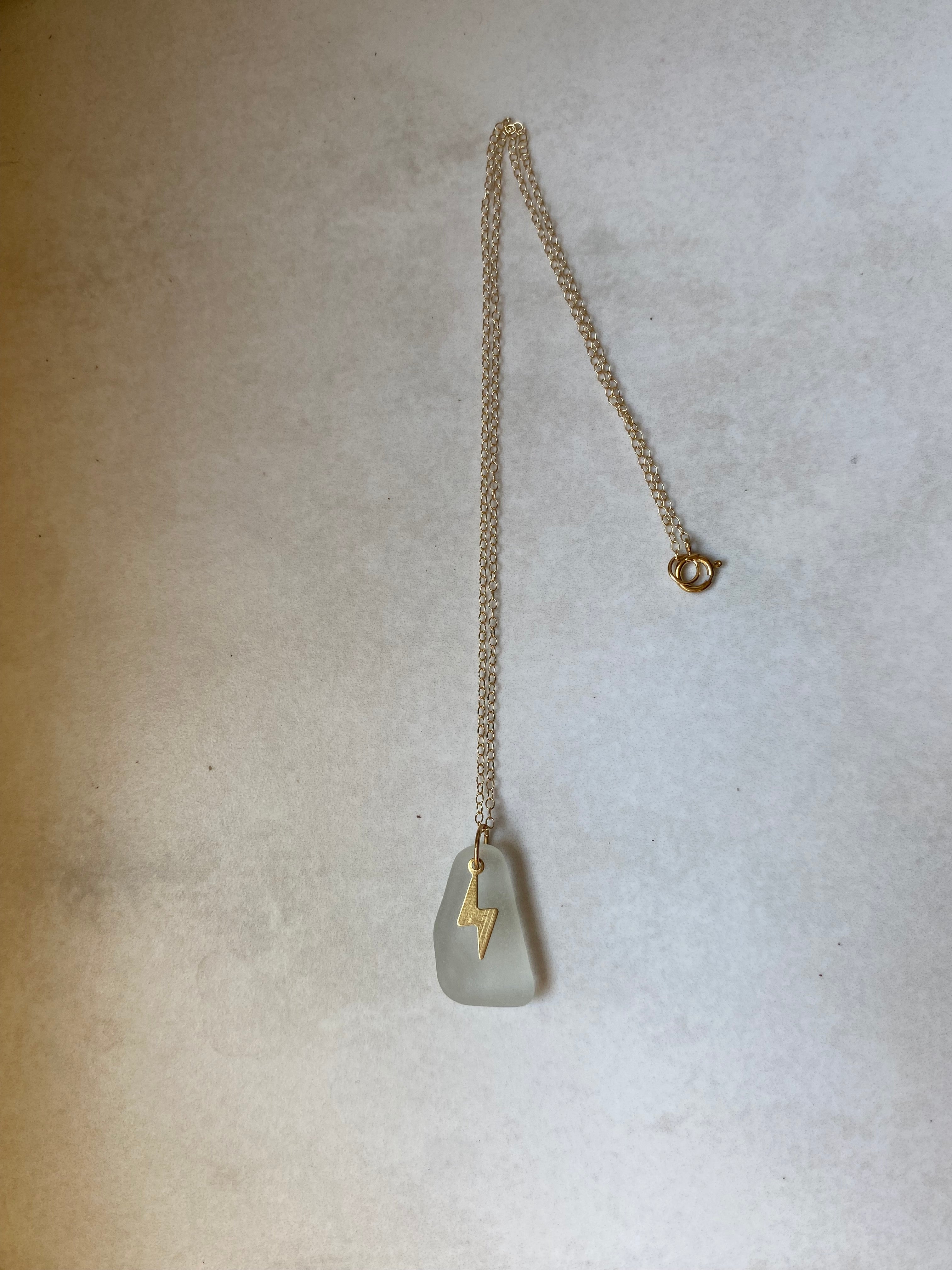 Joy sea glass necklace: Brass lightening bolt (white)