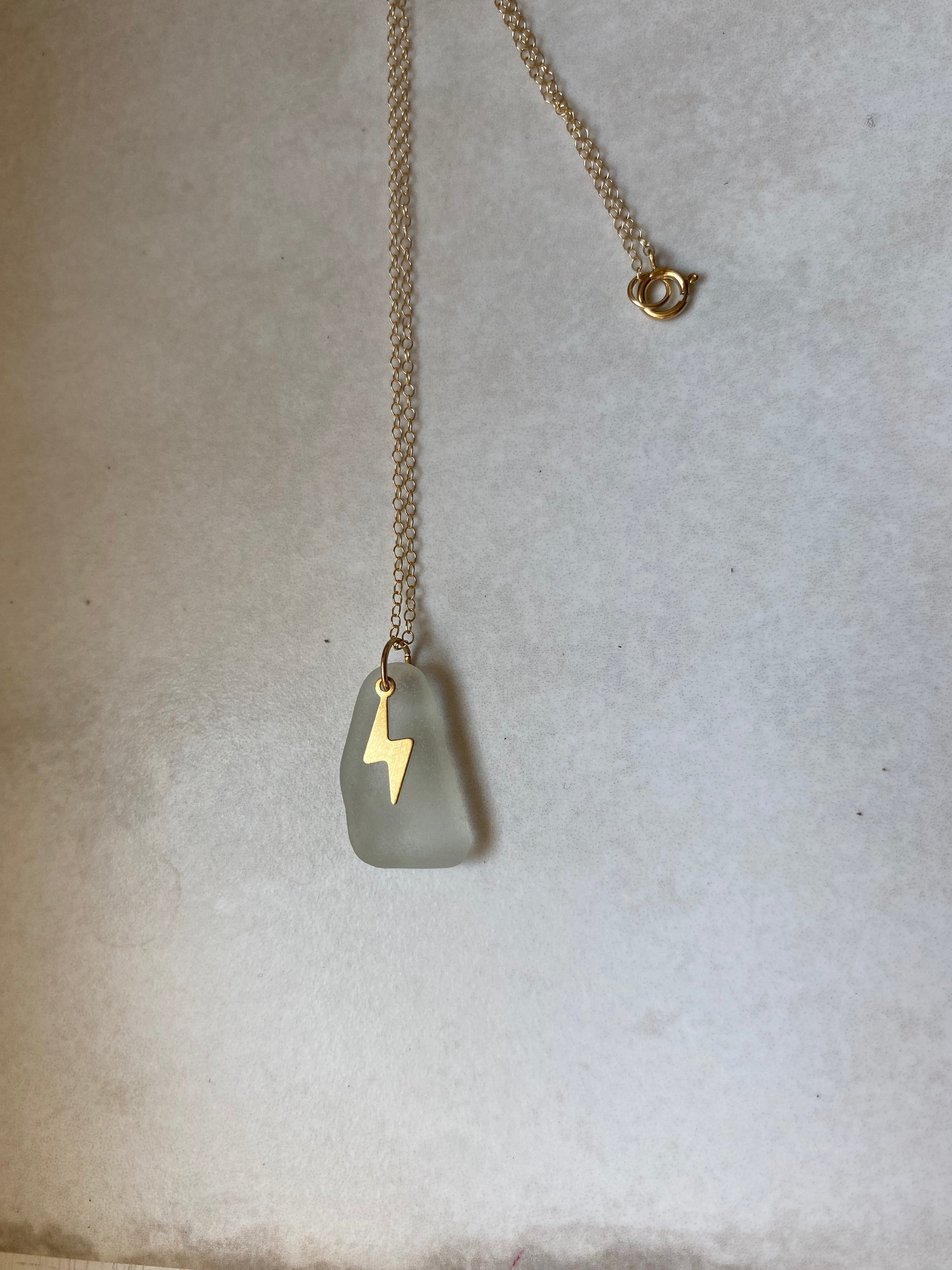 Joy sea glass necklace: Brass lightening bolt (white)